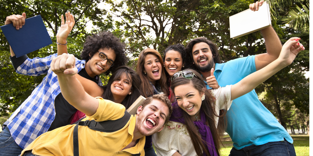 A group of young adults huddled together for a photo