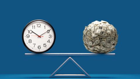 Picture of a clock on one side of a scale and money on the other.